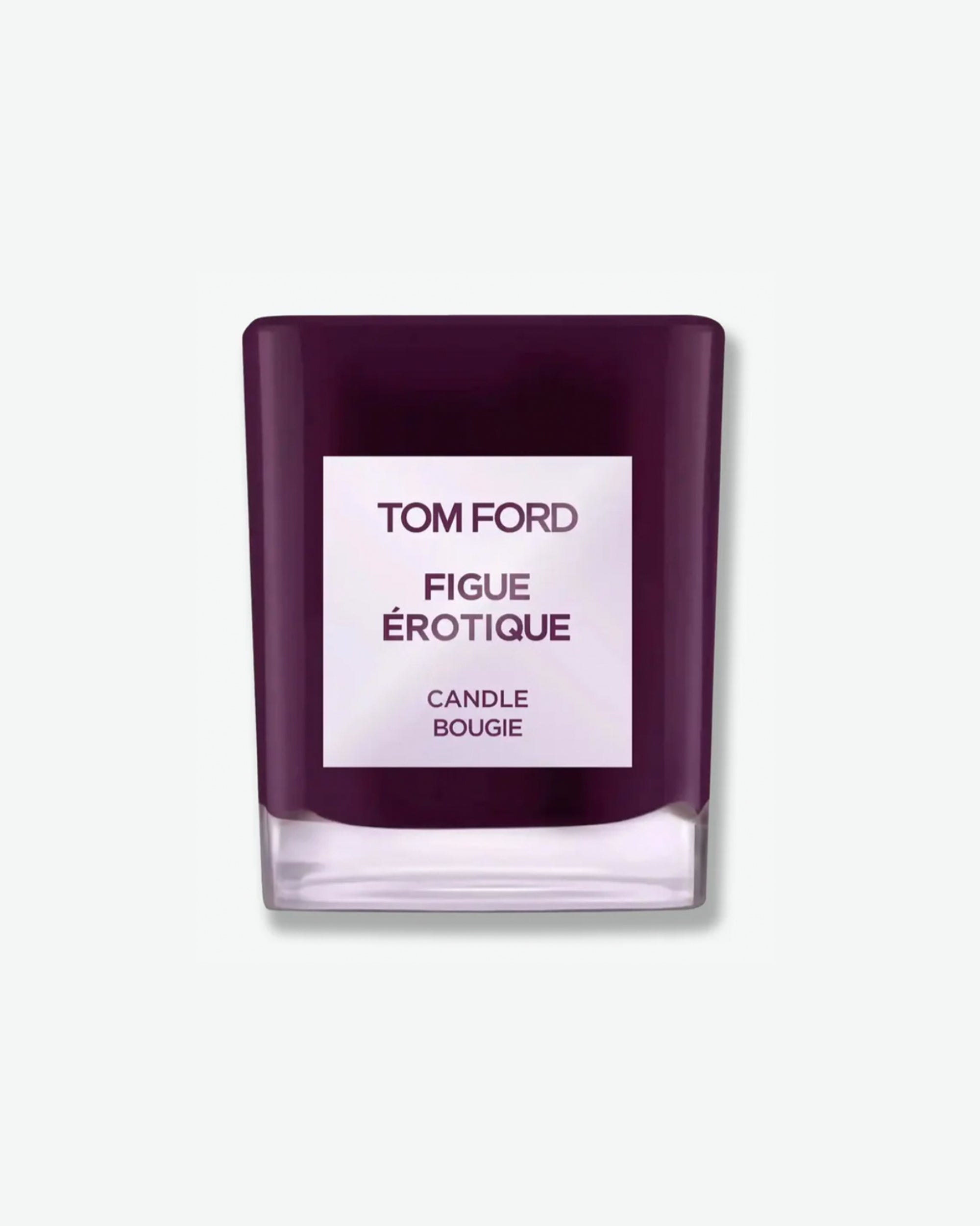Product shot of a Tom Ford Figue Érotique scented candle. The candle features a glossy, translucent deep plum or dark violet glass jar with a heavy clear glass bottom. Centered on the front is a square white label with dark text that reads "TOM FORD FIGUE ÉROTIQUE CANDLE BOUGIE". The item casts a soft shadow against a solid, minimal light grey background.