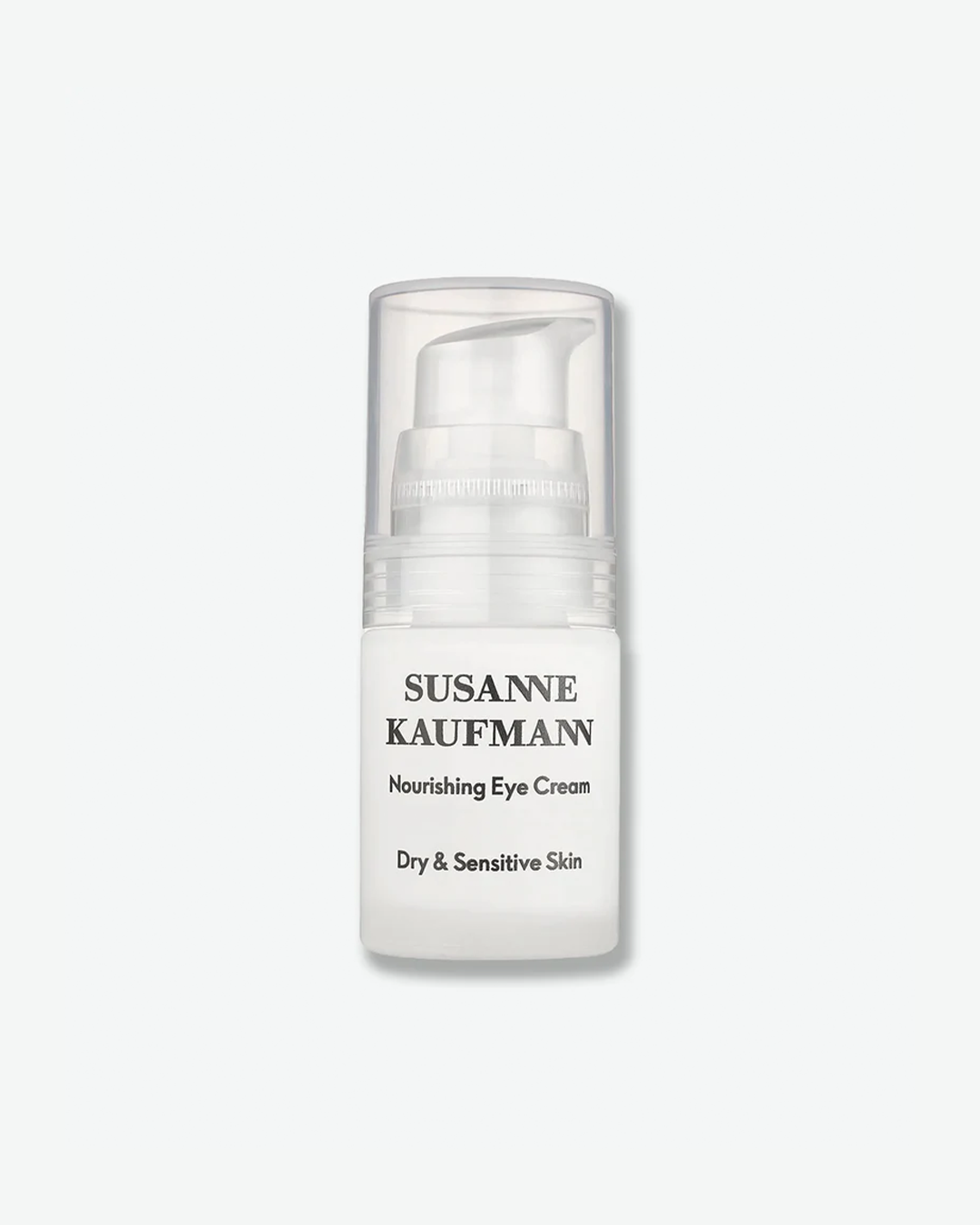 A product shot of a Susanne Kaufmann Nourishing Eye Cream pump bottle, centered against a plain light gray background. The small, short cylindrical bottle is made of solid white glass or plastic, featuring black text that reads "Nourishing Eye Cream" and "Dry & Sensitive Skin." It is fitted with a white pump dispenser covered by a clear plastic protective cap.