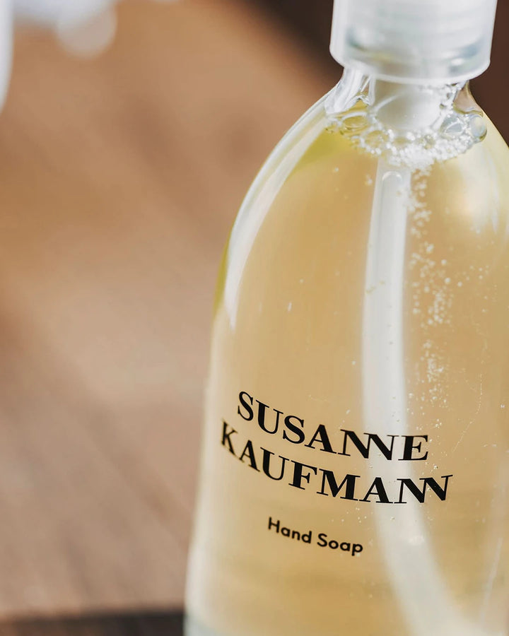 Bottle of Susanne Kaufmann hand soap with a blurred background