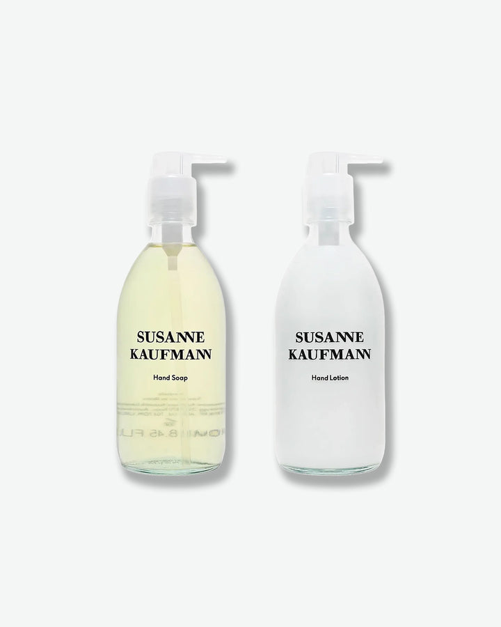 Two bottles of Susanne Kaufmann hand soap and lotion on a white background