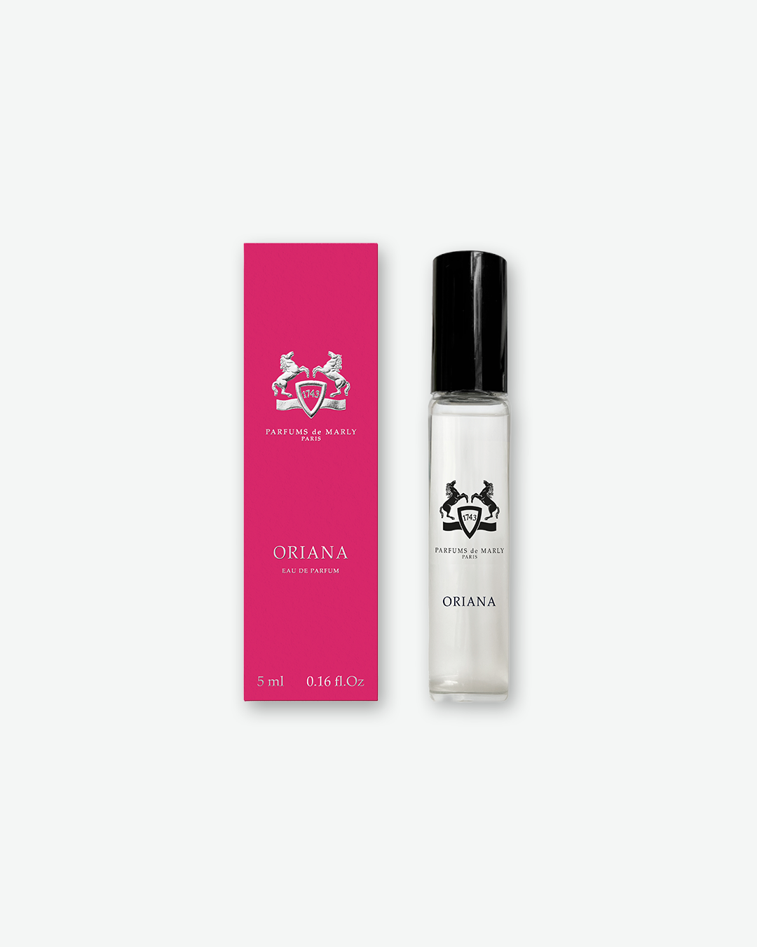 A Parfums de Marly "Oriana" Eau de Parfum travel size sample set. A small, clear glass spray vial filled with clear perfume and topped with a sleek black cap stands next to its vibrant magenta pink rectangular box. Both the box and the bottle prominently display the silver Parfums de Marly equestrian crest and the fragrance name "ORIANA".